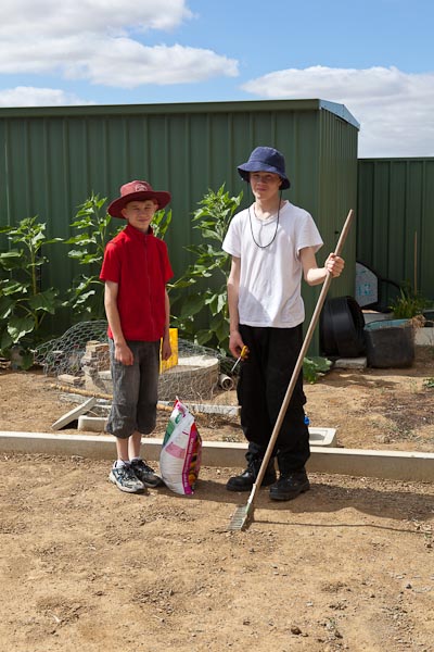 Our trusty child labourers, ready to spread the gypsum over the clay soil.